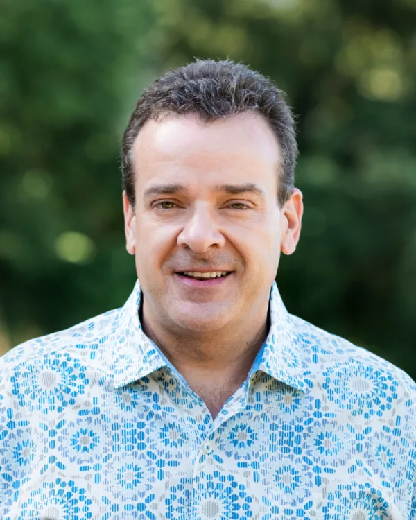 Robert Ott, principal of 4th Quarter Properties, outdoors in a patterned shirt