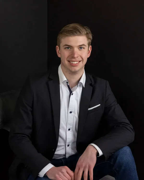 Tyler Muller of 4th Quarter Properties, smiling in a dark blazer